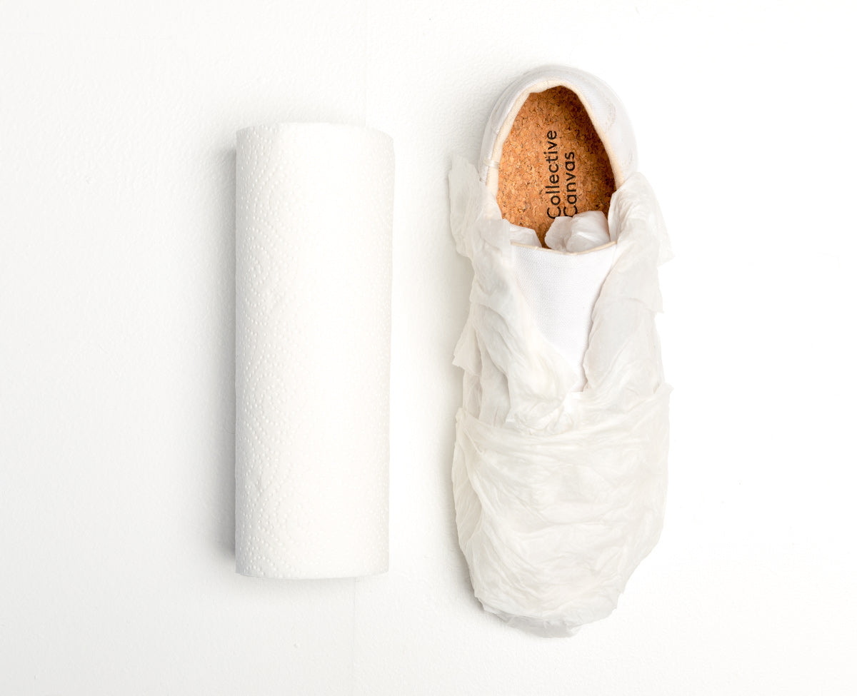 White Collective Canvas sneaker wrapped in damp paper towel.